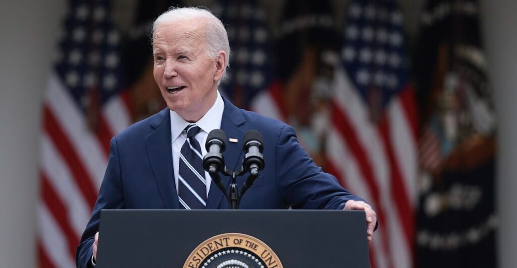 President Joe Biden stands behind a podium at a press conference.