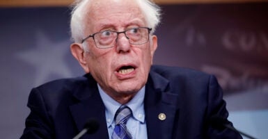 Bernie Sanders at podium in a dark suit and tie