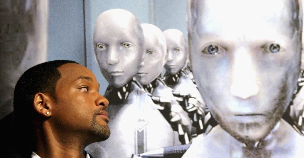 Actor Will Smith poses next to the robot from the movie, "I, Robot."