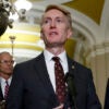 James Lankford in a suit speaks in front of a microphone