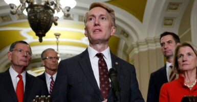 James Lankford in a suit speaks in front of a microphone