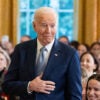 Joe Biden in a blue suit makes a fish face