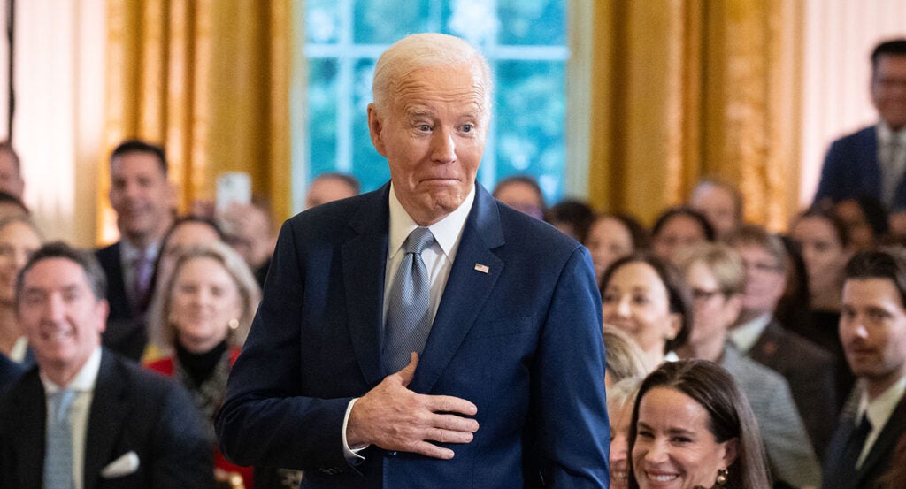 Joe Biden in a blue suit makes a fish face