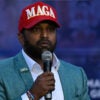 Kash Patel wearing a red MAGA (Make America Great Again) baseball cap