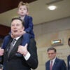 Elon Musk at the Capitol with a young son riding piggyback