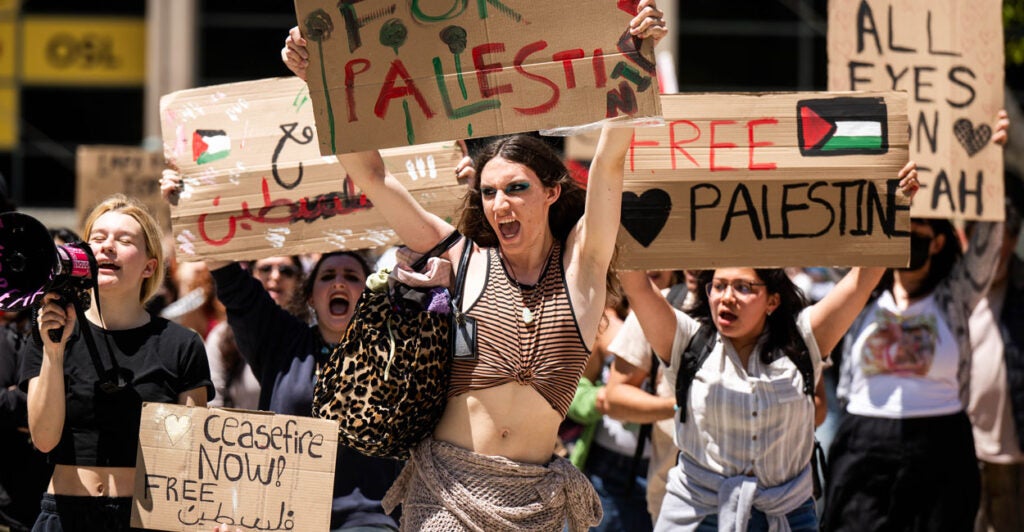 Young women protest with pro-Palestinian signs that say things like "Free Palestine"