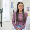 A teenage girl speaking to a nurse in a medical office