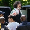 A pro-Palestinian student protester is arrested and about to be put in a police vehicle while he's screaming and surrounded by police