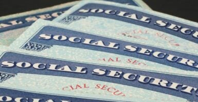 A stack of Social Security cards lay on top of each other.