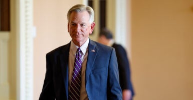 Sen. Tommy Tuberville walks the halls of Congress.