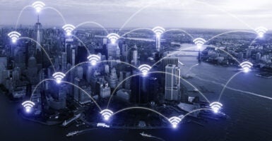 A photo illustration of Wi-Fi symbols overlaying a blue-tinted Manhattan cityscape.