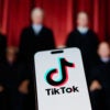 A semi-silhouetted photo of the justices of the Supreme Court with the logo of TikTok on a cellphone superimposed upon it