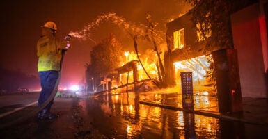 A firefighter battles a raging wildfire on Wednesday in Los Angeles.