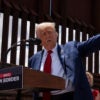 Donald Trump speaks at the U.S.-Mexico border in Arizona next to a very high fence