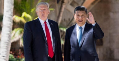 Chinese President Xi Jinping waves to the press as he walks with President Donald Trump at Trump's Mar-a-Lago estate in West Palm Beach, Florida, on April 7, 2017.