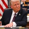 President Donald Trump signs executive orders in the Oval Office.