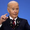 Joe Biden gestures in a suit