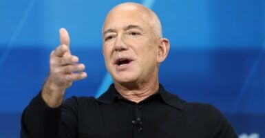 Billionaire Jeff Bezos motions with his right hand as he speaks.