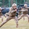 China's Armed Police officers hold rifles while yelling in a training exercise.