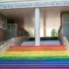 The steps leading inside to a college building have been painted the rainbow colors.