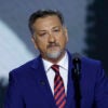 Medal of Honor recipient David Bellavia speaks in a blue suit