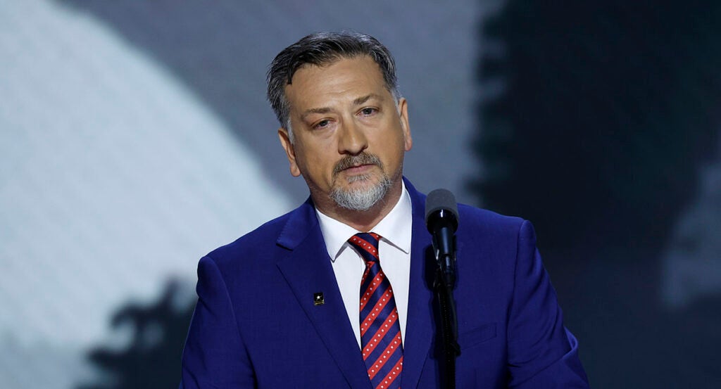 Medal of Honor recipient David Bellavia speaks in a blue suit