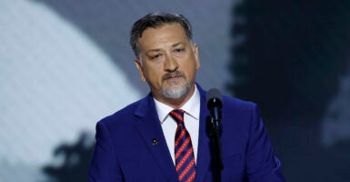 Medal of Honor recipient David Bellavia speaks in a blue suit