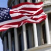 An American flag flies in front of the U.S. Capitol