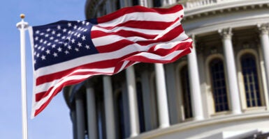 An American flag flies in front of the U.S. Capitol