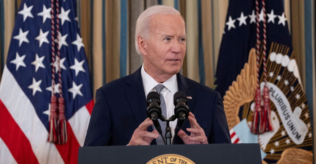 President Joe Biden speaks at a podium.