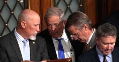 Republican Reps. Chip Roy of Texas, Ralph Norman of South Carolina, Tim Burchett of Tennessee, and Thomas Massie of Kentucky confer.