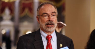 Rep. Andy Harris in a dark suit and red tie in the hallway of the U.S. Capitol