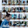 Women in Israel pass by a wall covered with photos of hostages being held by Hamas