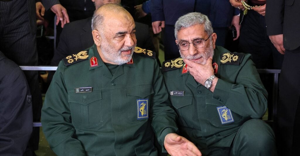 Head of Iranian revolutionary guard corps Hossein Salami and head of the Iranian Quds forces Ismael Ghaani sit next to each other at an event.