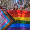 Woman holds LGBTQ flag