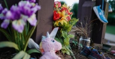 Flowers, sneakers and a stuffed animal are placed at a memorial site on the campus of the University of Georgia in memory of slain Laken Riley.