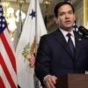 Marco Rubio stands with his hands resting on the podium.