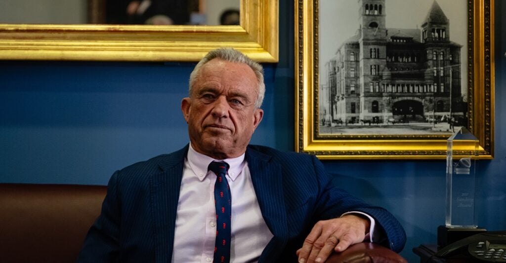 Robert F. Kenedy Jr. sits in a seat with his left arm on the arm rest.