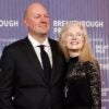 Marc Andreessen stands next to his wife with his hands by his side at an awards ceremony.