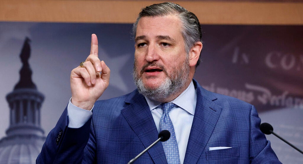 Sen. Ted Cruz raises his finger in a blue suit