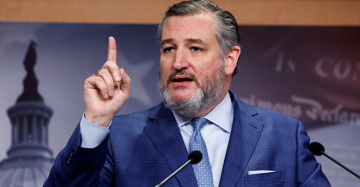 Sen. Ted Cruz raises his finger in a blue suit