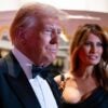 President Donald Trump stands next to his wife Melania at an event.