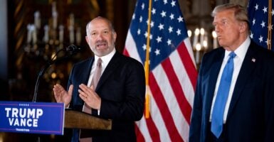 Donald Trump listens while standing to the side as Cantor Fitzgerald Chairman and CEO Howard Lutnick speaks during a news conference.