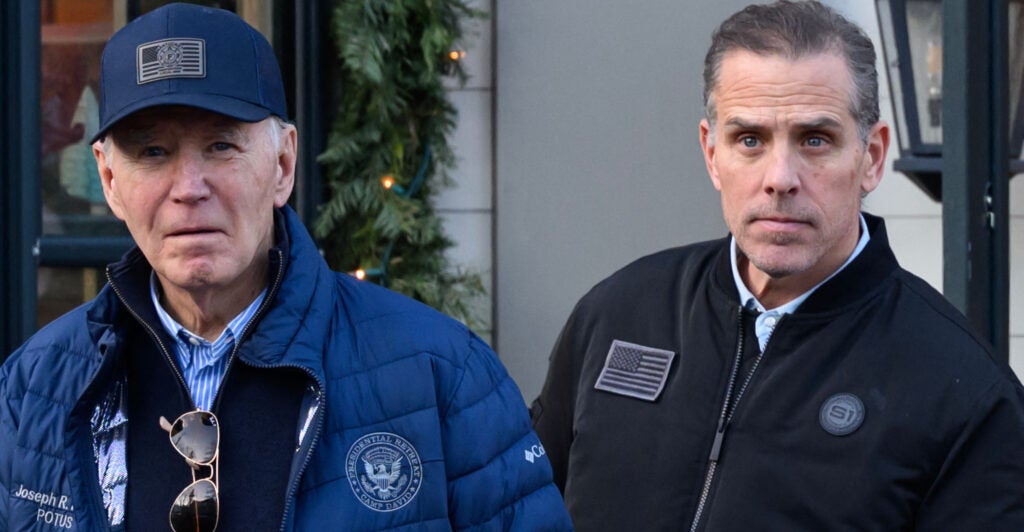 Joe Biden in a baseball cap and blue winter jacket next to son Hunter Biden in a dark winter jacket