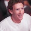 Facebook founder Mark Zuckerberg laughs while wearing a T-shirt.