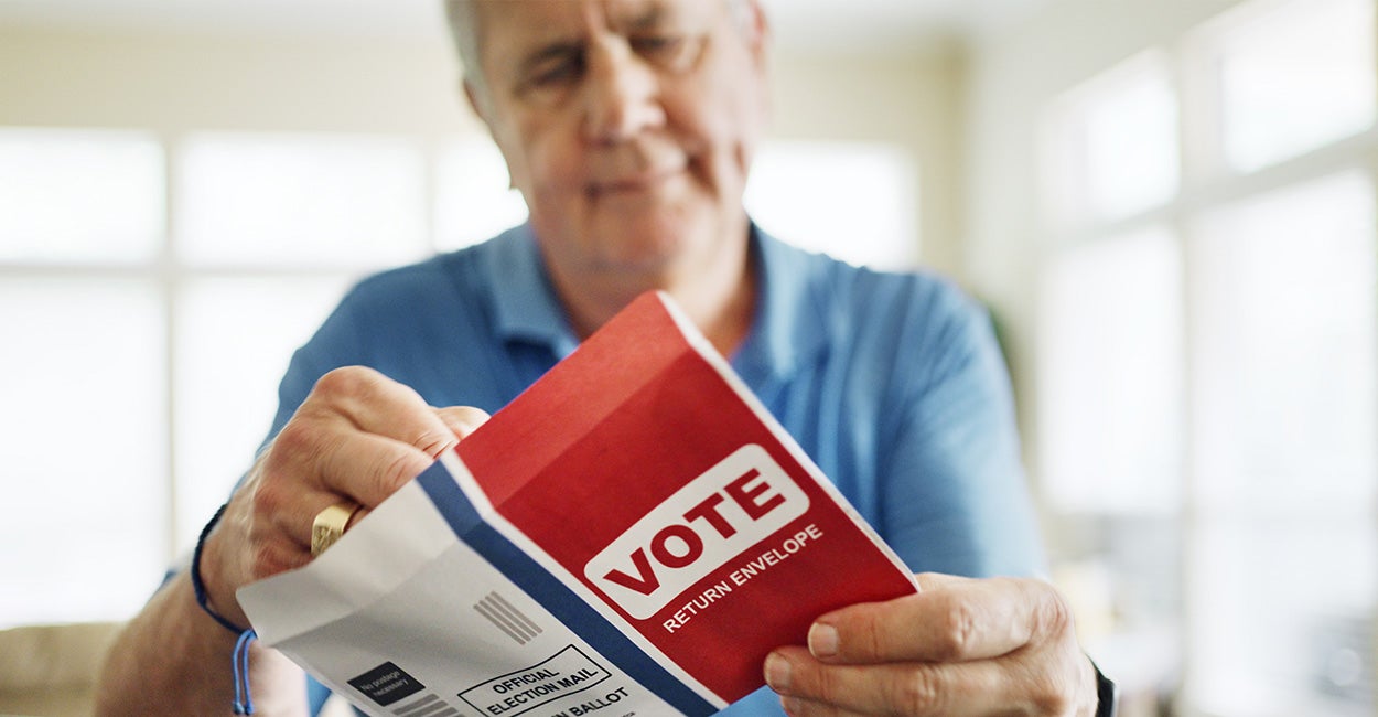 An elderly man votes.