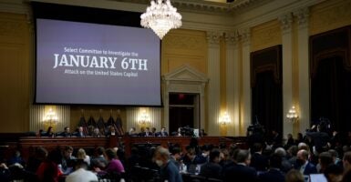 The words "January 6th" was displayed on a large video screen in the U.S. House select committee hearing.