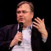 Tech billionaire Reid Hoffman holding a microphone