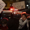 A protester holds a sign reading, "Free Palestine"