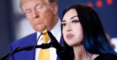 President Donald Trump listens as Alexis Nungaray, mother of 12-year-old Jocelyn Nungaray, speaks at the Austin-Bergstrom International Airport in Austin, Texas, on Oct. 25.